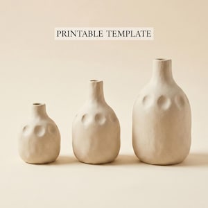 May include: Three beige ceramic vases of varying sizes. Each vase has a rounded body with a narrow neck and a series of circular indentations. The text "PRINTABLE TEMPLATE" is printed above the vases.