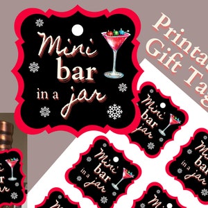 May include: Printable gift tag with a red border and black background. The tag features a martini glass with red liquid and colorful ornaments, and the text "Mini bar in a jar".