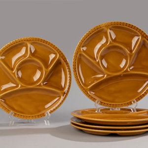 May include: Set of five brown ceramic divided plates with a beaded rim. Each plate has five sections, including a large center section.