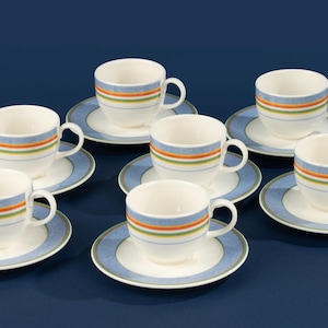 May include: A set of eight white teacups and saucers. Each cup and saucer has a blue rim and a band of orange, green, and yellow stripes. The saucers have a blue patterned border.