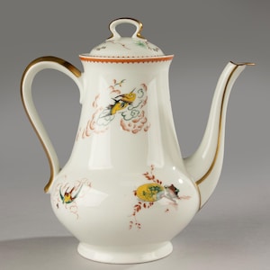 May include: White porcelain coffee pot with a lid, featuring a curved handle and spout. The pot is decorated with colorful bird and cloud motifs, accented with gold trim. A decorative piece for serving coffee or tea.