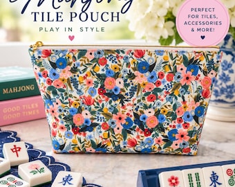 May include: A rectangular fabric pouch featuring a vibrant floral pattern with blue, pink, red, and yellow flowers on a white background. The pouch has a gold-toned zipper closure at the top and is designed to hold mahjong tiles and accessories.