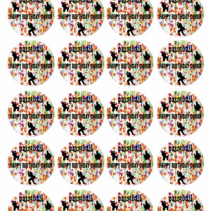 May include: Twenty-four round edible images for cupcakes or cookies. Each image features a paintball player silhouette with colorful paint splatters and the text "paintball" and "Happy Birthday David!"