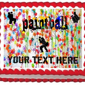 May include: A white cake with red frosting and a colorful paint splatter design. The cake is decorated with the word "paintball" and the text "YOUR TEXT HERE".
