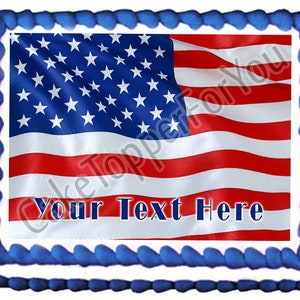 May include: A cake topper featuring a red, white, and blue American flag with the text "Your Text Here" printed below. The flag is waving in the wind and has a blue border.