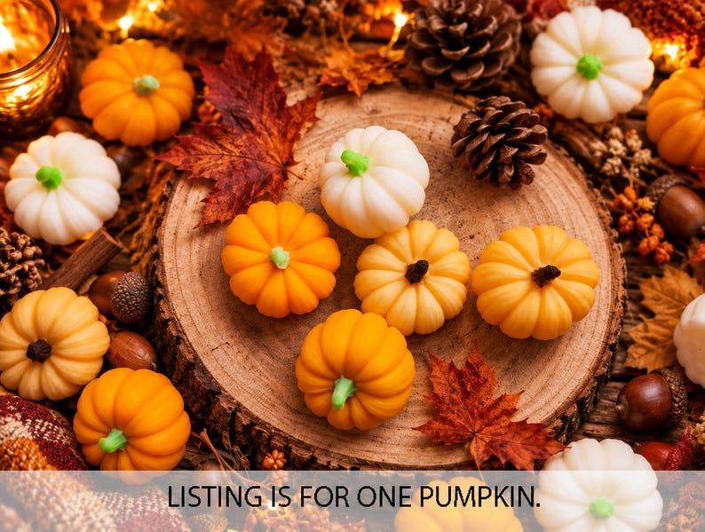May include: A collection of small, decorative pumpkins in shades of orange and white, featuring green stems. The pumpkins are arranged on a circular wooden slice surrounded by autumn leaves, pinecones, and acorns. Text reads: LISTING IS FOR ONE PUMPKIN.