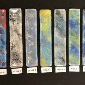 May include: Eight rectangular, colorful, abstract art pieces with a glossy finish. Each piece has a unique pattern of swirling colors, including red, blue, white, yellow, and black. The pieces are labeled with the text "W 56.P" followed by a number.