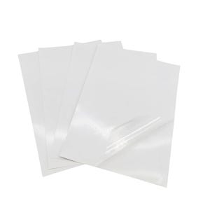 May include: A stack of four white sheets of adhesive-backed paper, with a clear protective layer on top.