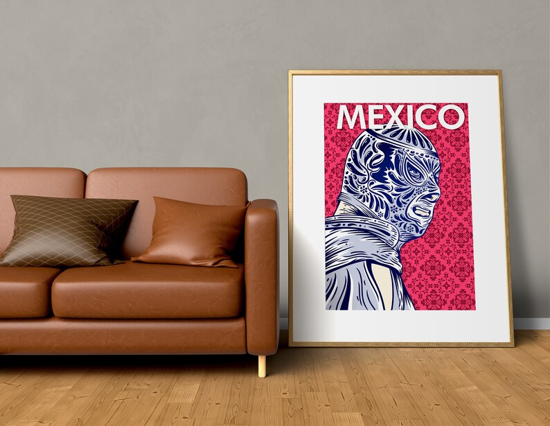 May include: A framed poster with a pink background and a blue and white illustration of a masked wrestler. The poster has the word "MEXICO" printed in white at the top.