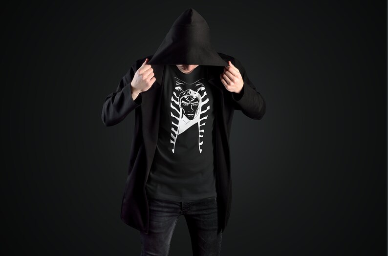 May include: A black hooded jacket with a black t-shirt underneath. The t-shirt features a white graphic of a character from Star Wars.