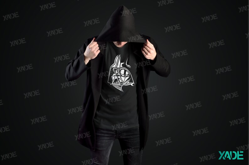 May include: A black hooded jacket with a black t-shirt underneath. The t-shirt has a white graphic of Darth Vader's face on it.