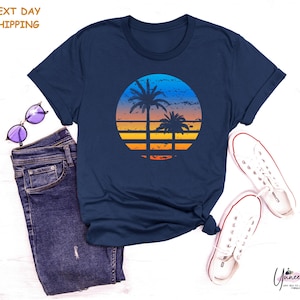 a t - shirt with a sunset and palm trees on it