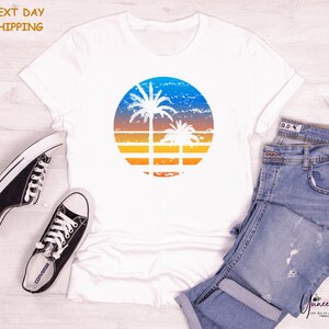 a white shirt with a palm tree on it