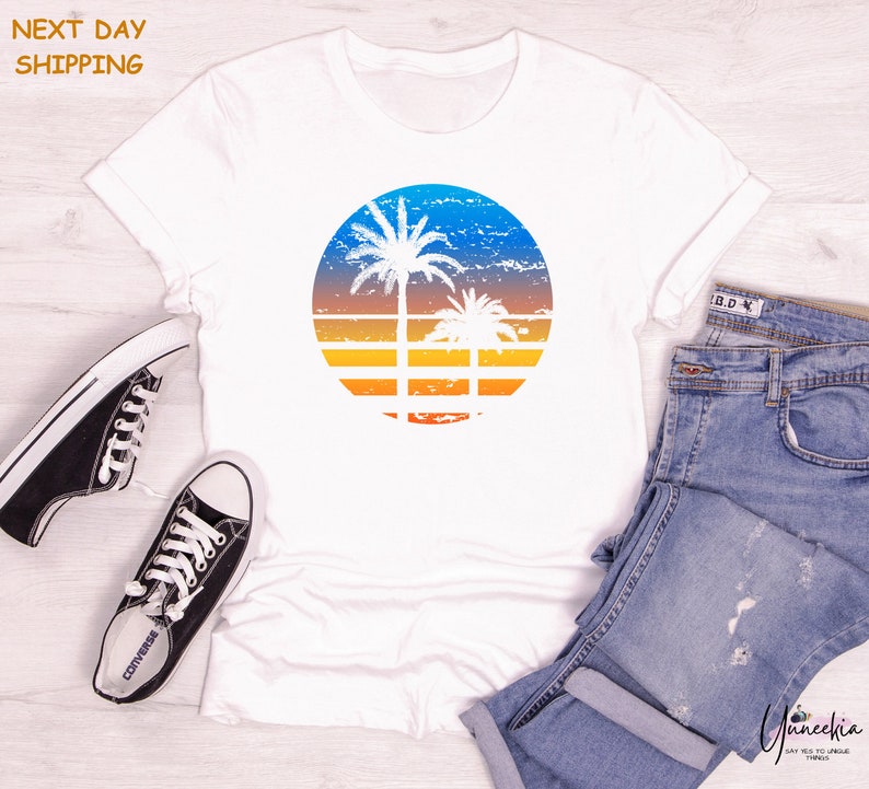 a white shirt with a palm tree on it