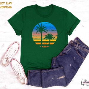 a green t - shirt with a palm tree on it