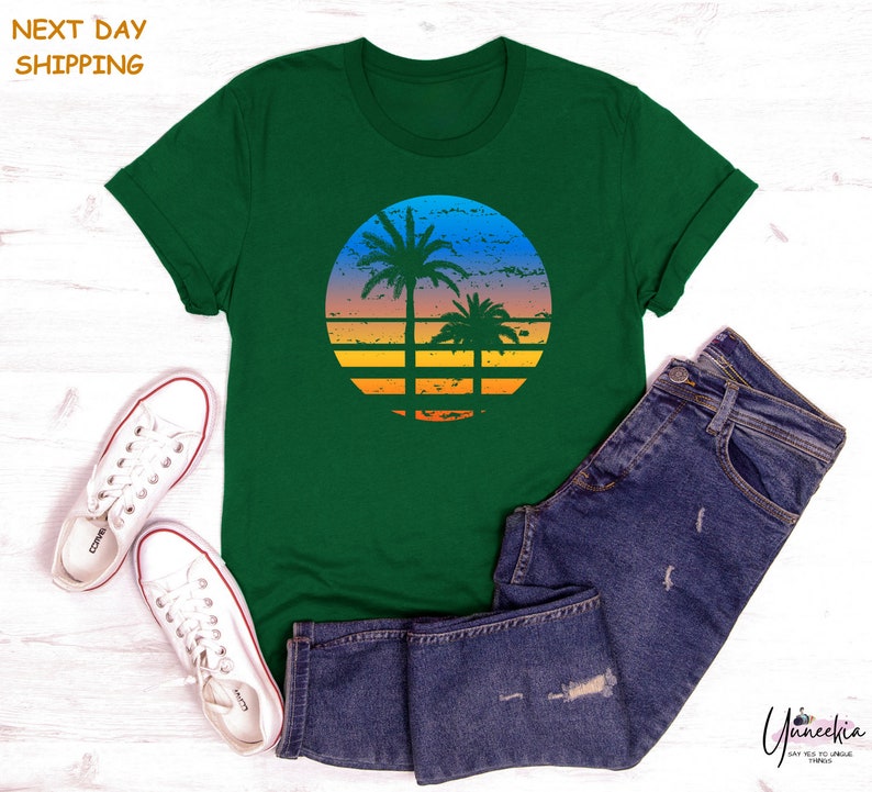a green t - shirt with a palm tree on it