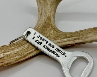 May include: Silver bottle opener keychain with the text "I don't get drunk, I get awesome."