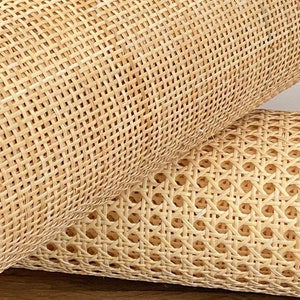 May include: Two rolls of natural cane webbing, a woven material used for chair seats and other furniture projects.