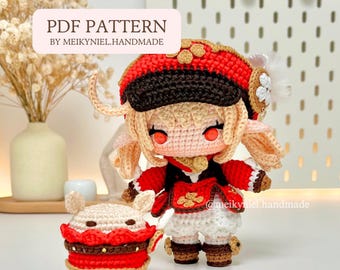 May include: Crocheted doll and companion piece in red, white, and tan. The doll wears a red hat with black trim, a red jacket, and white skirt. The companion piece is a small, round, tan and red object. The text "PDF PATTERN BY MEIKYNIEL.HANDMADE" is visible.