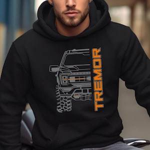 May include: Black hooded sweatshirt with a gray outline of a truck and the word "TREMOR" in orange lettering.