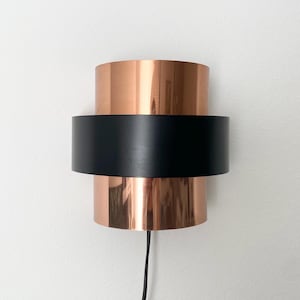 Copper and black metal sconce. Scandinavian mid century modern design.