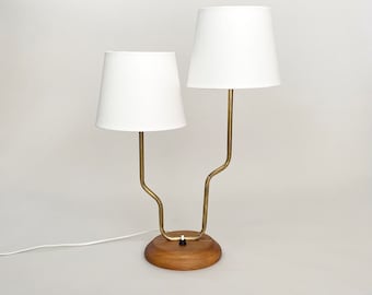 A brass and wood double arm table lamp from Sweden. Scandinavian mid century modern 50s 60s
