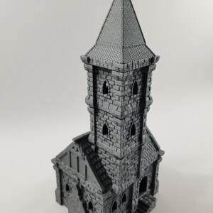 May include: A gray 3D printed miniature of a stone tower with a pointed roof and small windows. The tower is a building model for tabletop games or miniature painting.