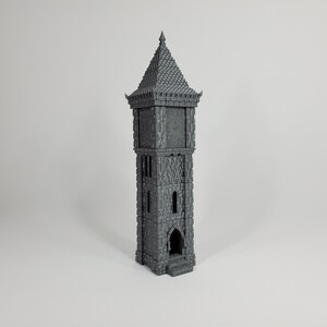May include: A gray, stone clock tower with a pointed roof and a clock face. The tower has a small arched doorway at the base.