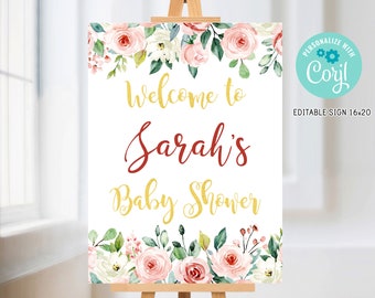 May include: A white welcome sign with pink and white floral border. The sign reads "Welcome to Sarah's Baby Shower" in gold and burgundy lettering. The sign is on an easel.