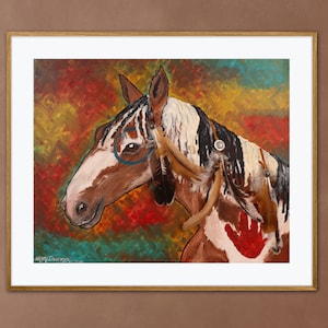 May include: A painting of a horse with a white and black coat, blue eyes, and a red handprint on its side. The horse is adorned with feathers and a beaded necklace. The background is a colorful abstract design.