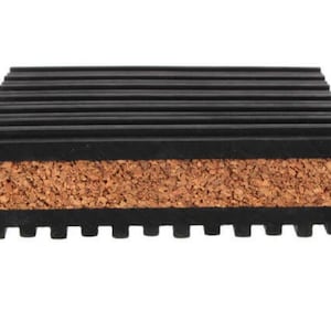 May include: A rectangular coaster with a layered design. The top and bottom layers are black with a ridged texture, while the middle layer is natural cork. The coaster is designed to protect surfaces from heat and moisture.