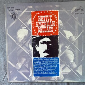 May include: Vintage vinyl record album cover for "Native American Ballads." The cover features a red and white title, a black and white illustration of a man, and a list of artists. The RCA Victor logo is in the upper right corner.