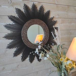 Round mirror in black-stained wood surrounded by two-tone seaweed.réf Ju0174