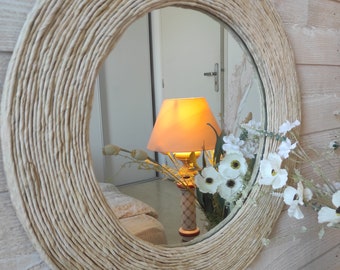 French designer. Large round mirror surrounded by wood covered with ecru corn rope