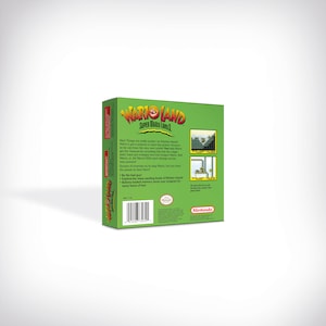 May include: Green and red Nintendo Game Boy cartridge box for the game Wario Land: Super Mario Land 3. The back of the box features a description of the game and a barcode.