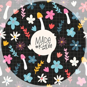 May include: A whimsical pattern featuring colorful flowers, mushrooms, and foliage on a black grid background. The design includes pink, blue, yellow, and white elements. A white circle with the text "MADE by Kylee" is in the center.
