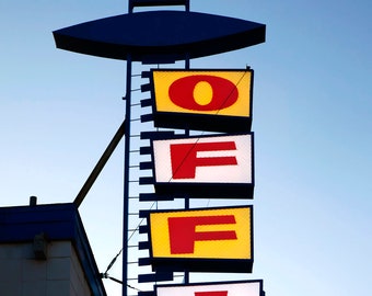 Lit motel office sign at dusk, US.