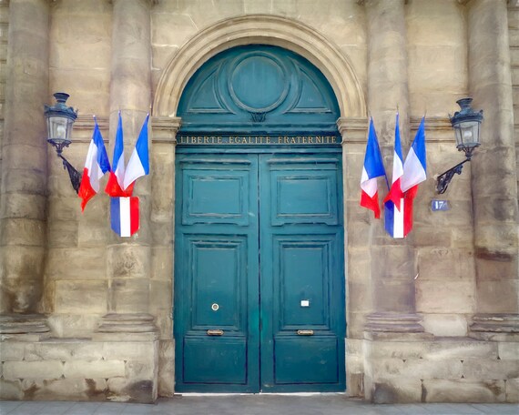 Patriotic doorway with French flags in Paris.