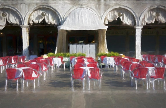 Cafe and red chairs in St. Mark's Square, Venice, Italy.