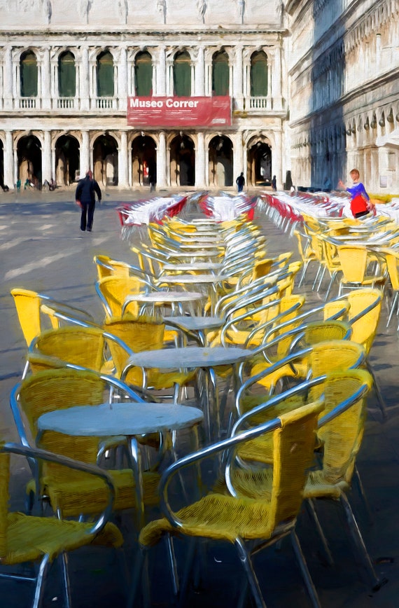 Cafe and yellow chairs in St. Mark's Square, Venice, Italy.