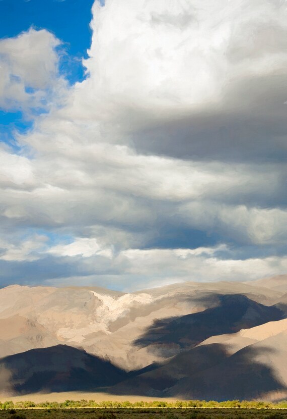Cumulus clouds cast shadows on the White Mountains, California.