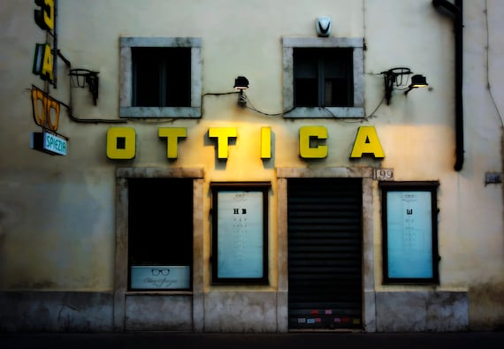 Italian optometrist shop at night in Bologna, Italy.