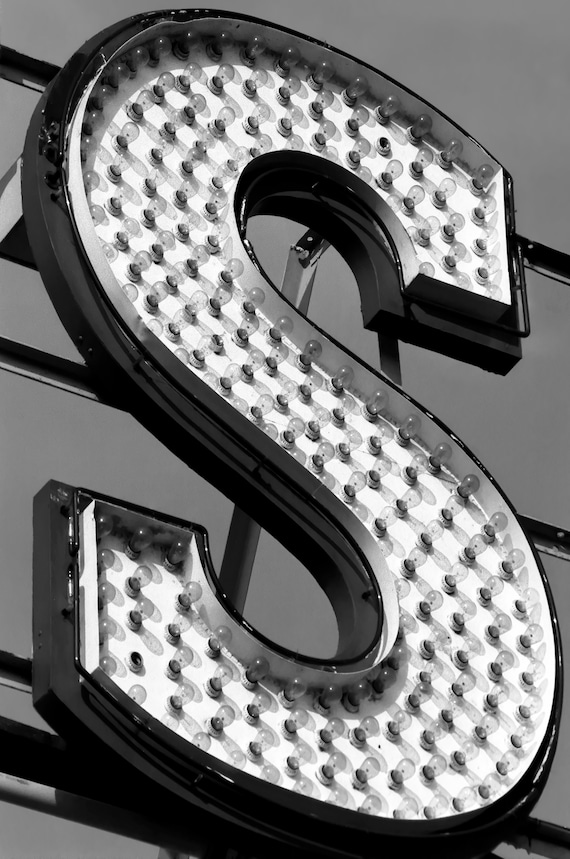 Photo of the letter S in bulbs in an outdoor sign.