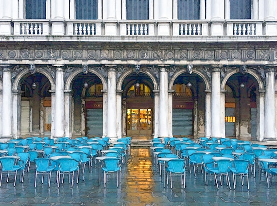 Cafe with blue chairs in the rain at St. Mark's square, Venice.