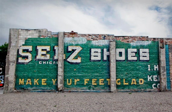 Ad for shoes painted on the side of an old brick building, Fallon, NV.