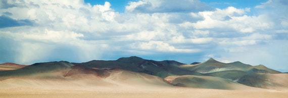 Clouds and showers over the Brown Knob Hills in Nevada desert, US.