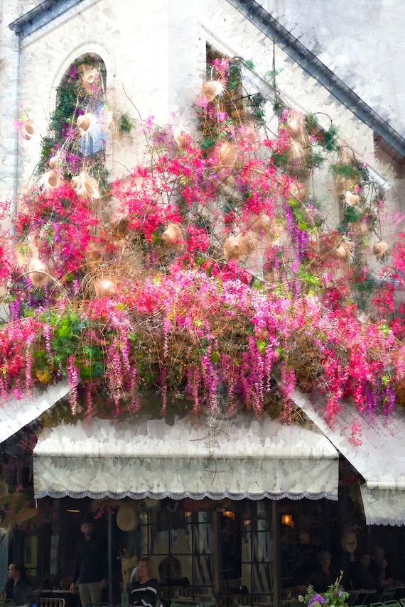 Paris cafe bistro with hanging spring pink blooms and hats.
