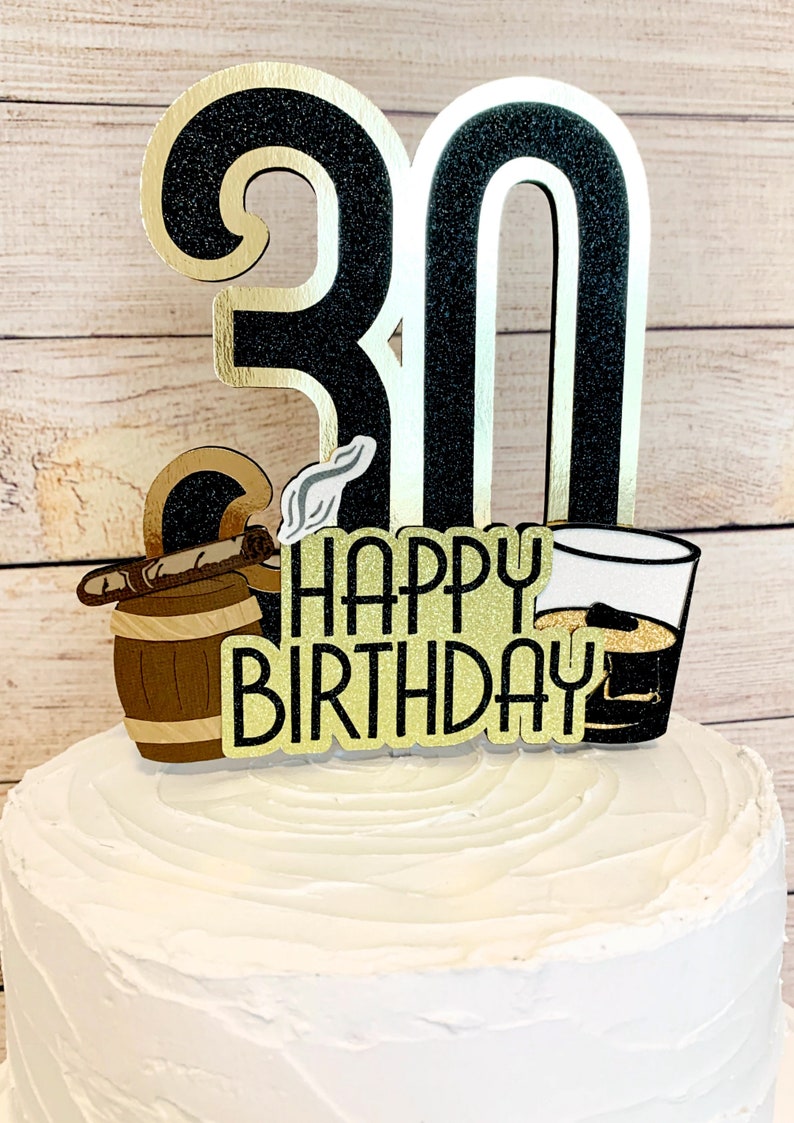 May include: Black and gold glitter cake topper with the number 30, a cigar, a barrel, a glass of whiskey, and the text "Happy Birthday".