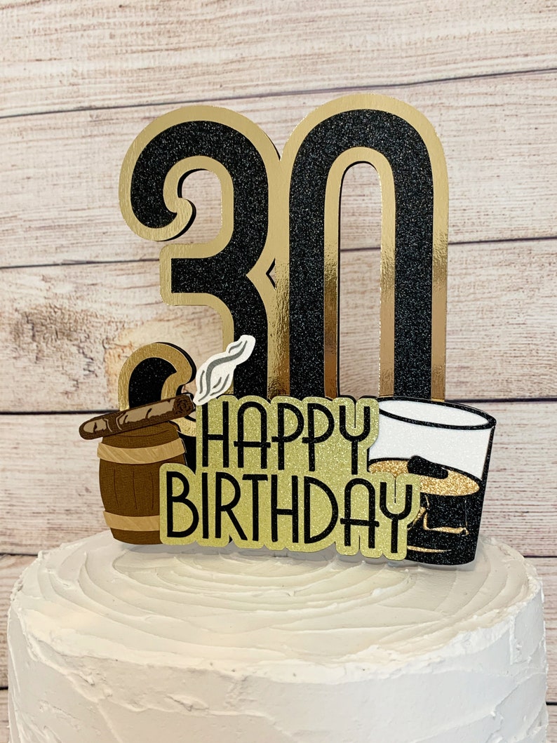 May include: Black and gold glitter cake topper with the number 30, the words "Happy Birthday", a barrel with a cigar, and a glass of whiskey.