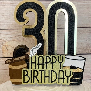 May include: Black and gold glitter cake topper with the number 30, a cigar and barrel, a glass of whiskey, and the words "Happy Birthday".
